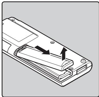 OLYMPUS WS-650 DNS - Appuyez légèrement sur la flèche et faites coulisser le couvercle du logement de la pile pour l'ouvrir. - 1