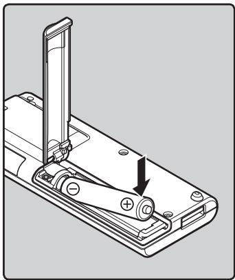 OLYMPUS WS-650 DNS - Appuyez légèrement sur la flèche et faites coulisser le couvercle du logement de la pile pour l'ouvrir. - 2
