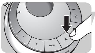 Diagram showing a hand pressing a circular component with labeled buttons and an arrow indicating direction, including symbols like 'PAGE' and 'R'.