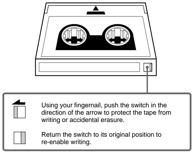 Using your fingernail, push the switch in the direction of the arrow to protect the tape from writing or accidental erasure. Return the switch to its original position to re-enable writing.
