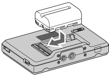 SONY CLM-V55 - Push the battery in gently in the direction shown, then slide it to the left while still pushing. - 1