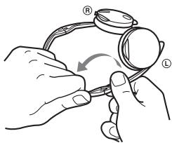 Diagram showing hands holding a eyeglasses with labeled parts and an arrow indicating rotation or adjustment.