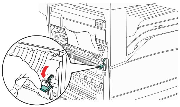 Line drawing of a hand using a tool to adjust or install electronic components, with an inset showing a red arrow indicating the component (no text or symbols present).