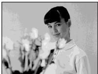 Black-and-white portrait of a woman holding flowers (no text or symbols visible)