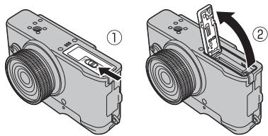 FUJI X20 - Ouvrez le couvercle du compartment de la batterie. - 1