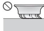 Diagram illustrating a mechanical assembly process with labeled steps ① and ②, showing hand positioning and component insertion.