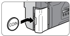 NIKON ONE TOUCH ZOOM 90-QD - Open the battery chamber lid using a coin or equivalent. - 1