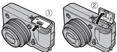 FUJIFILM PREMIUM X-PRO1 - Ouvrez le couvercle du compartment de la batterie. - 1