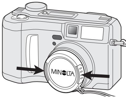 MINOLTA DIMAGE S304 - Fixation de la courioie de COU et du bouchon d'objectif - 1