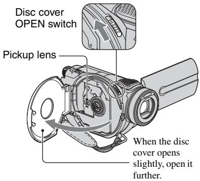 Disc cover OPEN switch Pickup lens When the disc cover opens slightly, open it further.