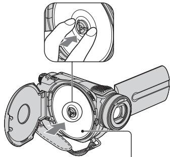 SONY DCR-DVD905E - Set the disc with the recording side facing your camcorder, then press the center of the disc until it clicks. - 1