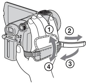 Diagram of a digital camera with numbered parts and directional arrows indicating motion or operation