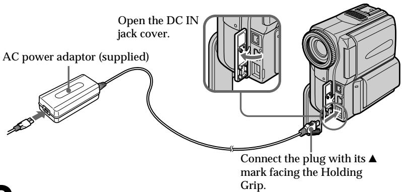 Open the DC IN jack cover. AC power adaptor (supplied) Connect the plug with its ▲ mark facing the Holding Grip.
