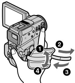 Diagram of a digital camera with numbered parts and directional arrows indicating motion or operation