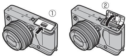 FUJIFILM X-E1 - Ouvrez le couvercle du compartiment de la batterie. - 1