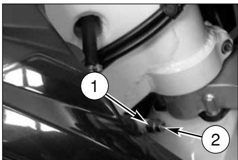 Close-up mechanical component with numbered annotations indicating parts of a tool or assembly.