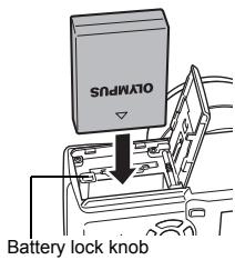OLYMPUS C-765 UZ - Loading the battery Align the battery as shown and insert it into the battery compartment until the battery is locked in position with the battery lock knob. - 2