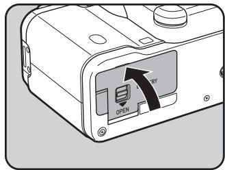 PENTAX K-01 - Poussez l'interrupteur de déverrouillage de la trappe de protection du logement de la batterie vers la position OPEN (①) pour déverrouiller. - 3