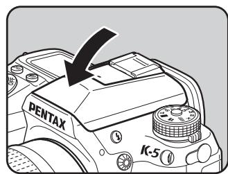 PENTAX K-5 - Appuyez sur la partie indiquée sur l'illustration pour rétracter le flash incorpore. - 1