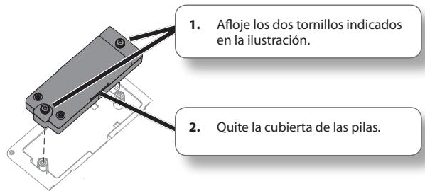 1. Afloje los dos tornillos indicados en la ilustración. 2. Quite la cubierta de las pilas.