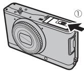 FUJIFILM XF1 - Ouvrez le couvercle du compartment de la batterie. - 1