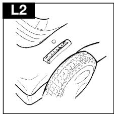 Line drawing of a hand holding a small object, possibly a tool or device, with no visible text or symbols.