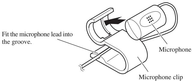 Fit the microphone lead into the groove. Microphone Microphone clip