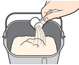 PANASONIC SD-BH104 - Versez les ingrédients dosés dans le moule à pain - 1