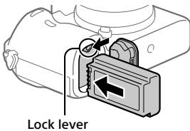 SONY ALPHA A7 III - Insert the battery pack while pressing the lock lever with the tip of the battery until the battery locks into place. - 1