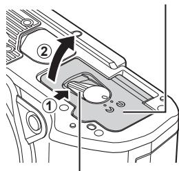 OLYMPUS OM-D E-M1X - Ouvrez le couvercle du compartment de la batterie. - 1