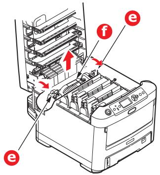 Diagram of a printer with labeled parts (e, f) and directional arrows indicating process flow or movement.