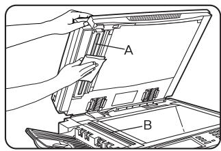 Diagram showing hands installing or adjusting a device with labeled parts A and B, likely illustrating a mechanical or electronic assembly.