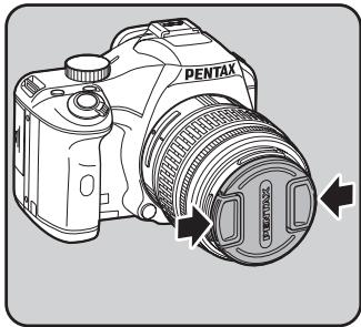 PENTAX KM+KC+18/55+50/200 - Pour-retirer le bouchon avant de l'objectif, enforcez les parties indiquées sur l'illustration. - 1