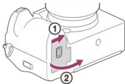 SONY alpha7siii - Faites glisser le commutateur sur le couvercle de batterie pour ouvrir le couvercle. - 1