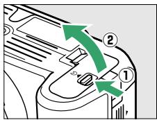 NIKON D3200 18-55 UR II - Ouvrir le volet du logement pour accumulateur. - 1