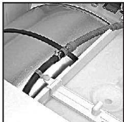 Close-up of a mechanical component with coiled hoses and connectors (no visible text or symbols)