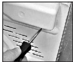 Close-up of a hand using a tool to mark a surface with parallel lines.