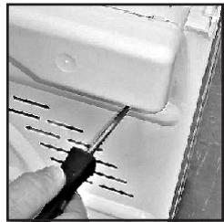 Close-up of a hand using a screwdriver to adjust or install a white plastic component (no visible text or symbols)