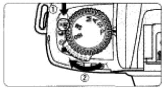 NIKON F80D - Set the film advance mode selector to S (single-frame shooting) while pressing the film advance mode selector lock release. - 1