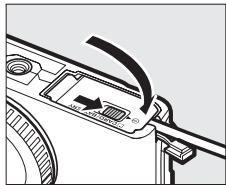 NIKON 1 J3 - Close the battery-chamber/memory card slot cover. - 1