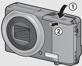 RICOH CX2 - Close the battery/card cover and slide it back into place. - 1