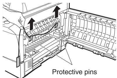 OLIVETTI D-COPIA 120/150 - Remove the adhesive tape from the front cover and remove the two protective pins from the fusing unit by pulling the strings upward one at a time. - 2