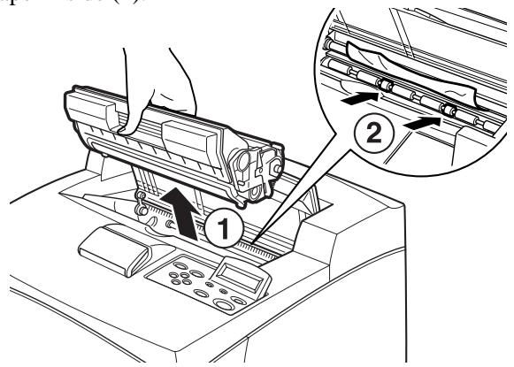 Diagram showing a hand operating a machine with labeled parts, including numbered annotations 1 and 2.
