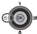 NIKON COOLPIX P300 - Press the rotary multi selector ⚙ (self-timer). - 1