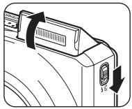 NIKON COOLPIX S9100 - Slide the ↘ (flash pop-up) control. - 1