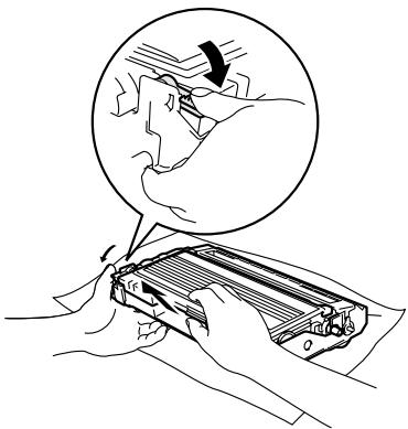 BROTHER 2820 - Hold down the lock lever on the left and pull the toner cartridge out of the drum unit. Take out the jammed paper if there is any inside the drum unit. - 1
