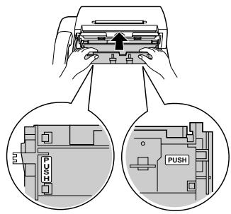 Diagram showing hand pressing a device with PUSH instructions for mechanical components