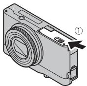FUJIFILM XQ2 - Open the battery-chamber cover. - 1