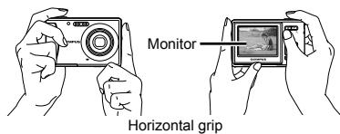 OLYMPUS T-100 - Hold the camera and compose the shot. - 1