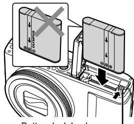 OLYMPUS XZ-10 - Insert the battery while sliding the battery lock knob in the direction of the arrow. - 1